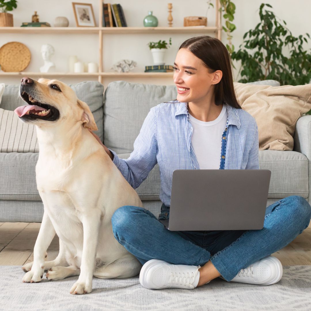 Woman with laptop and emotional support dog